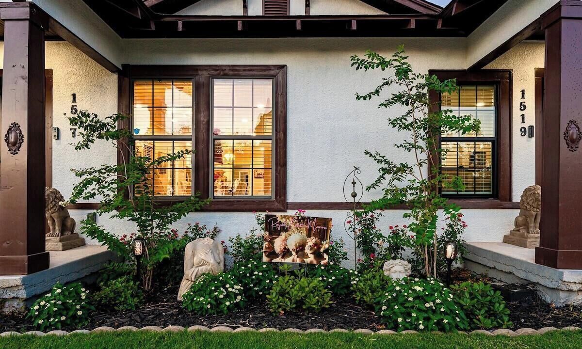 A building with a porch, two windows, and a number '1519' on the wall.