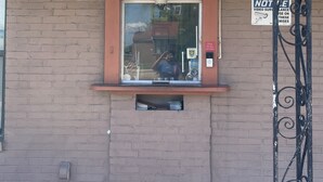 A motel office with a sign indicating it's open. - Economy Inn San Marco (Jacksonville)