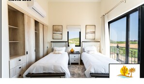Two single beds with white linens, nightstands, and a wardrobe.