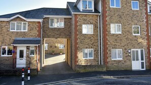 A multi-story residential building with a brick facade, multiple windows, and a front entrance. - 1 bedroom accommodation in Ventnor (Ventnor)