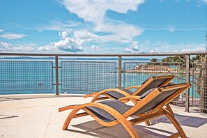 Two wooden lounge chairs with cushions, a pool, and a view of the sea and mountains. - Panorama Prestige Penthouse- BEST LOCATION IN TOWN (Split)