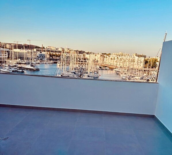 A balcony with a view of a marina filled with boats and yachts.