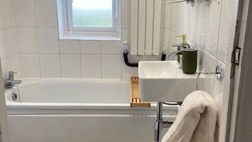 Combined shower/bathtub, deep-soaking bathtub, hair dryer, towels