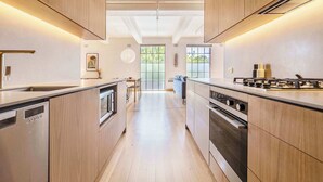 A modern kitchen with wooden cabinets, a dishwasher, an oven, and a gas stove.