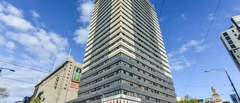 A tall, modern building with a distinctive zigzag pattern on its facade.