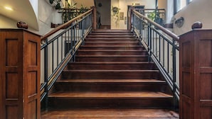 A wooden staircase with black railings and a door at the top. - Warehouse conversion in historic Dovers building (Melbourne)