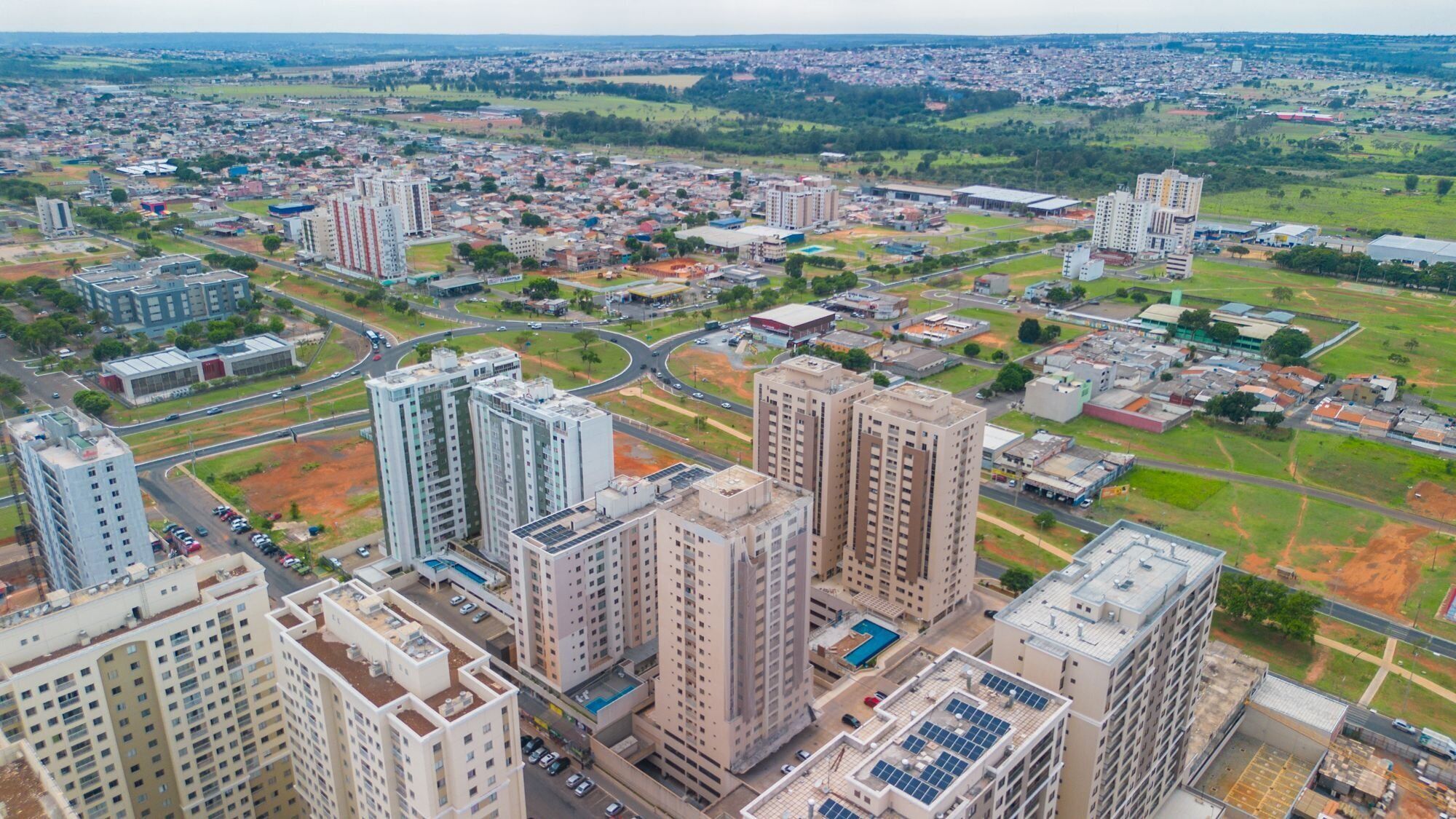 A high-rise residential building complex with multiple apartment buildings, roads, and surrounding greenery.