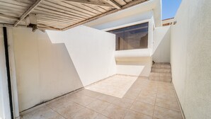 A clean, white-walled room with a tiled floor and a sloped ceiling.