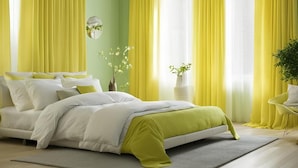 A modern bedroom with a bed, yellow curtains, and a green accent wall. - Captivating 3-bed House in Nottingham (Nottingham)