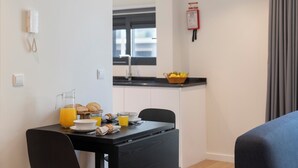 A modern kitchen with a black countertop, a sink, and a window above it. - Holidays in Funchal - Golden City B (Funchal)