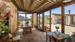 A rustic patio with wooden furniture, potted plants, and a view of the surrounding area. - Gorgeous home in Santa Croce Camerina (Santa Croce Camerina)