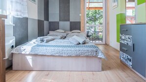 A bedroom with a bed, a window, and a door leading to a balcony. - 2 osobowy by Interhome (Warnowo)