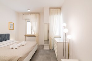 Una camera da letto con un letto, un comodino e uno specchio illuminato.