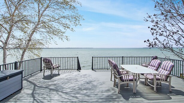 A deck with outdoor seating and a view of the sea. - Ottertail Lakefront 3BR. Boat lift. Cozy. Awesome! (Ottertail)