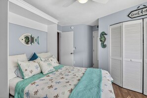 A bedroom with a bed, a closet, and a door.