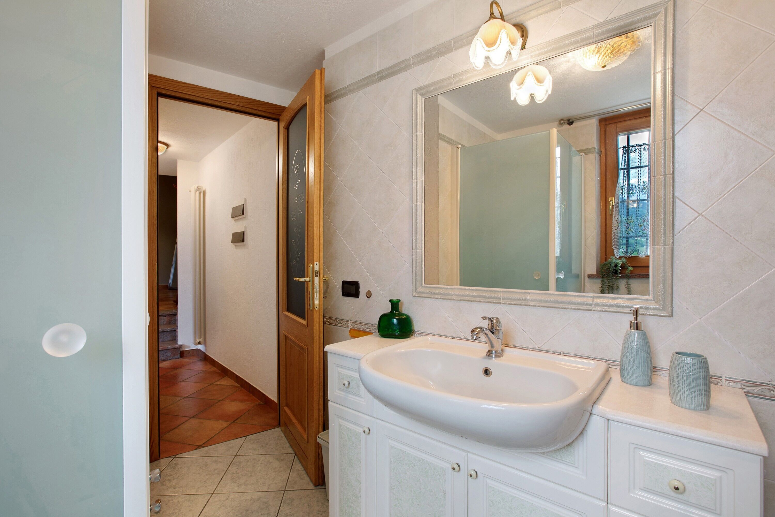 Une salle de bain avec un lavabo, un miroir et des placards.