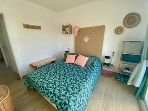 Ein Schlafzimmer mit Bett, Nachttisch und einer kleinen Ablagefläche.