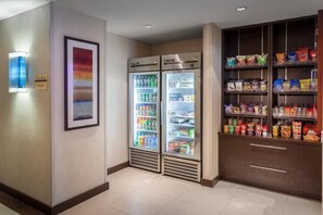 A hotel room with a minibar, a refrigerator stocked with beverages, and a snack shelf. - King Studio Near Atek Pest Control Inc MIA (Miami)