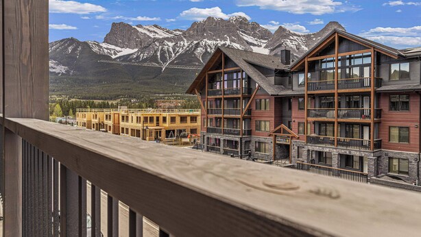 A hotel with a balcony overlooking a mountain range. - Spring Creek Vacations 2 BR Premier Condo 315TM (Canmore)