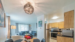 A modern kitchen with wooden cabinets, a built-in oven, and a stainless steel refrigerator. - Your Nordic Retreat (Anchorage)
