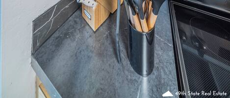 A kitchen with wooden cabinets, a toaster, a microwave, and a stove.