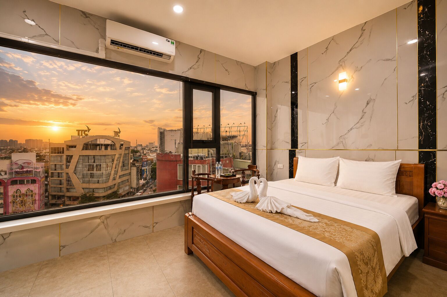 A hotel room with a large bed, a view of the cityscape, and a modern design.
