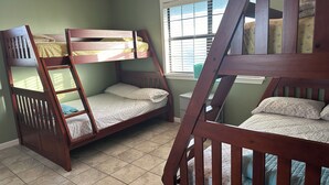 A room with bunk beds, a window with blinds, and a ceiling fan. - Fishing camp in Falgout Canal Marina! (theriot)