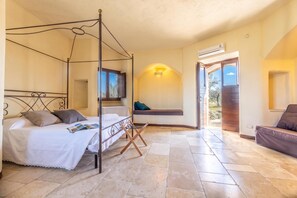 A four-poster bed with a magazine, a bench with cushions, and an air conditioning unit. - Pagliara Il Morige 6 In The Countryside, Galatone, Italy (Galatone)