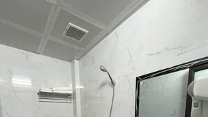 A bathroom with a toilet, sink, shower, and a mirror. - Hoa Cương Hotel 2 (Ha Giang 1)