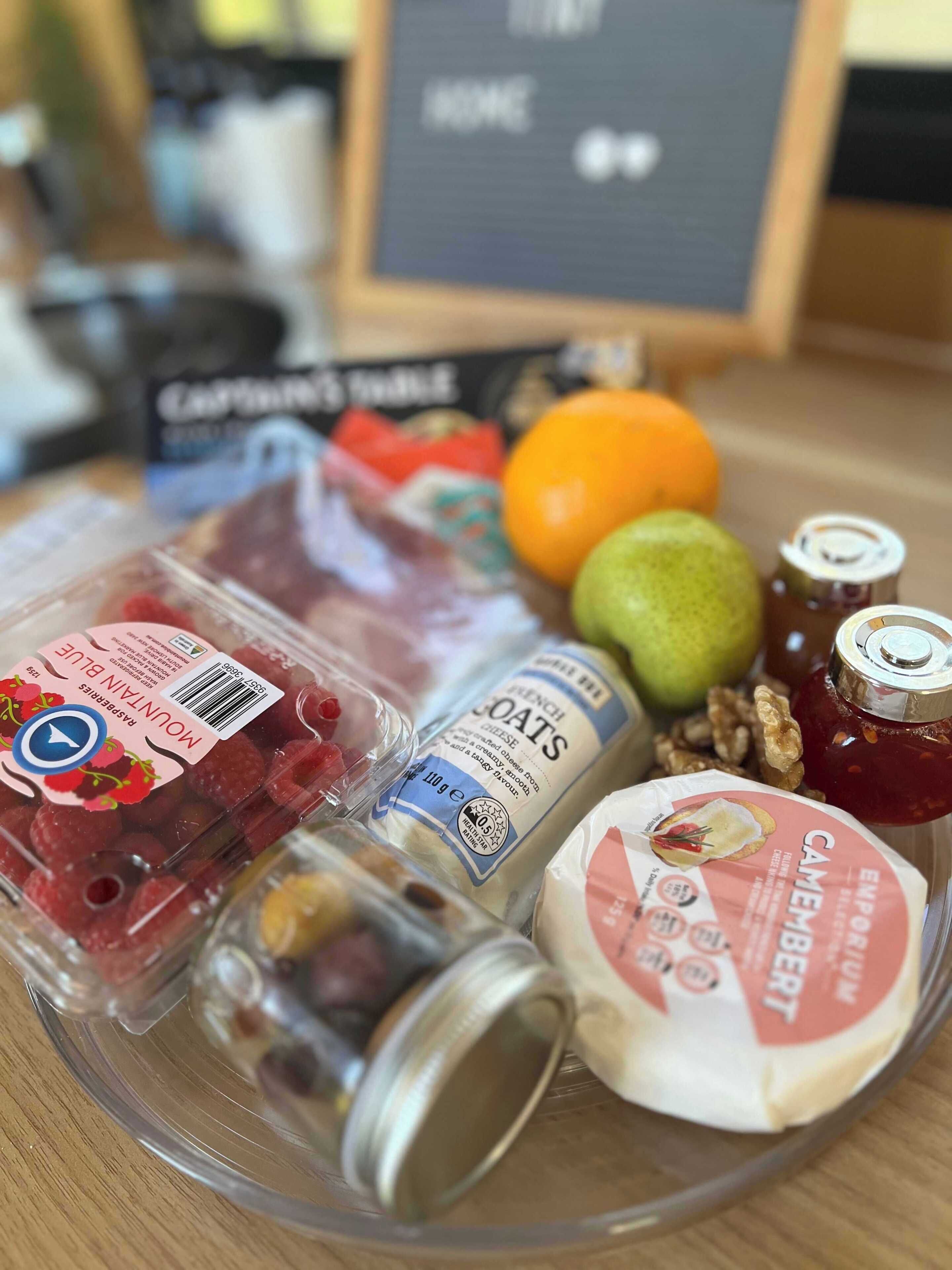 A variety of food items including cheese, fruits, and nuts on a table.