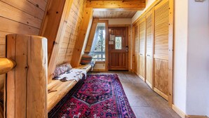 A wooden interior with a bench, a patterned rug, and a door leading outside. - 4BD w/Lake Views - Near Beach and Slopes (Tahoe City)