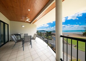 Outdoor dining - Whitsunday Beachfront Apartment on Coral Esplanade (Cannonvale)