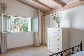 A room with a large window, a white dresser, and a bed with a metal frame. - Comfortable house in the countryside with garden near the sea (Vernole)