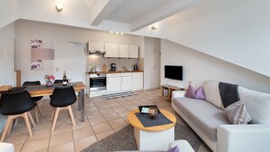 Eine moderne Wohnung mit Essbereich, Küche und Wohnraum.