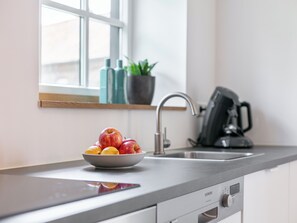 Fridge, stovetop, dishwasher, coffee/tea maker