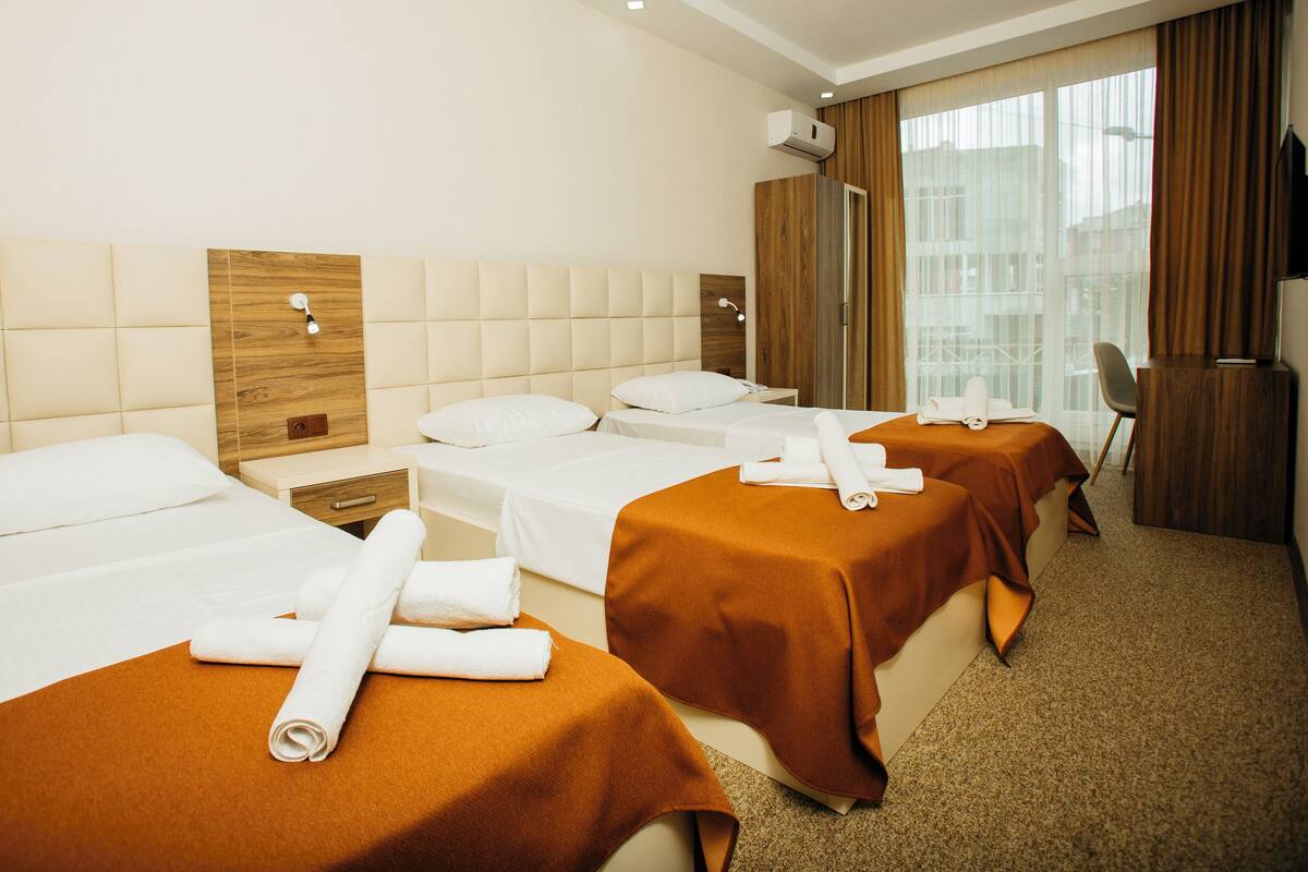 Standard Triple Room | In-room safe, desk, laptop workspace, blackout drapes