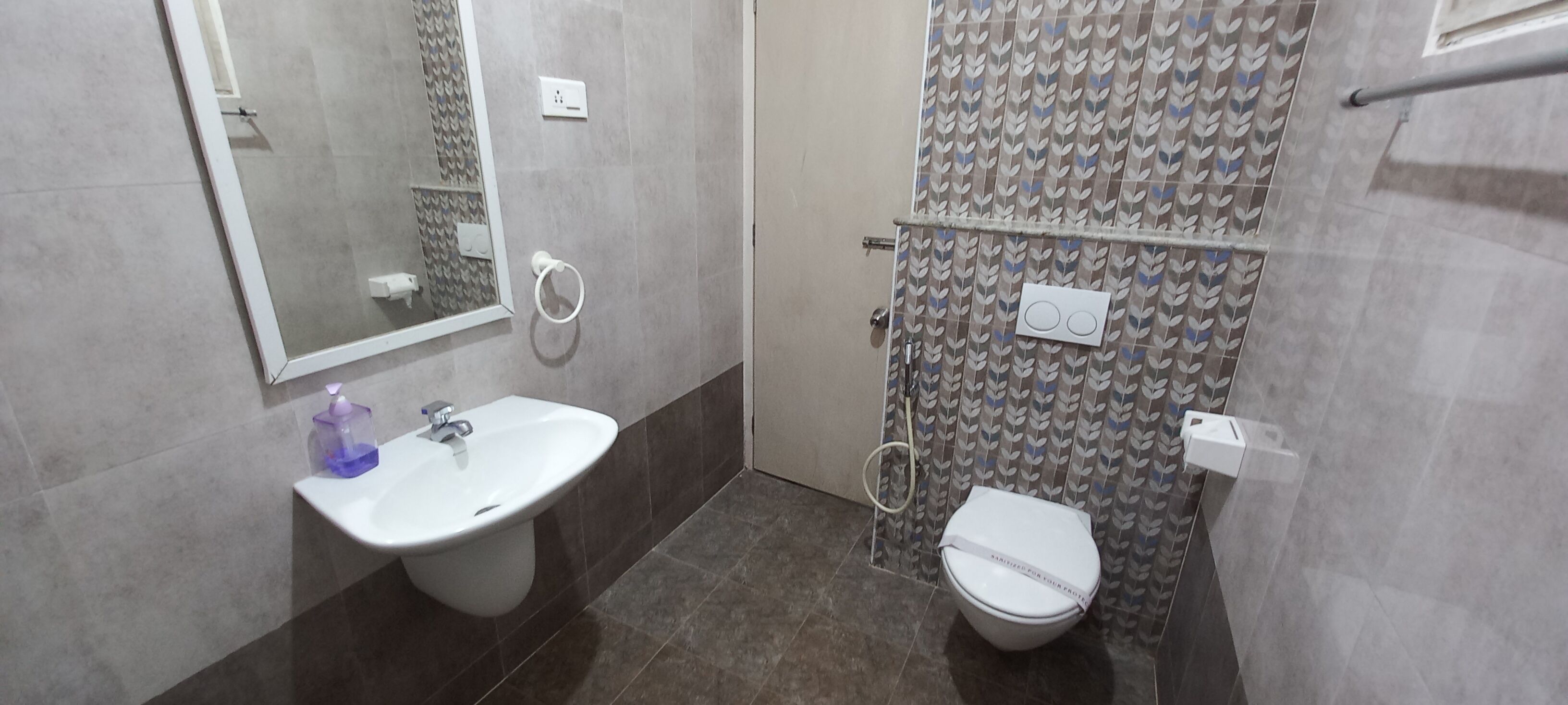 A bathroom with a sink, toilet, and shower area.