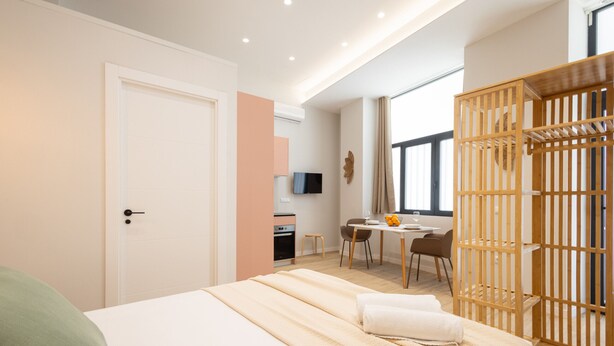 Une chambre d’hôtel moderne équipée d’un lit, d’un bureau et d’un coin repas.