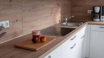 Fridge, stovetop, dishwasher, coffee/tea maker