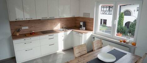 Fridge, stovetop, dishwasher, coffee/tea maker