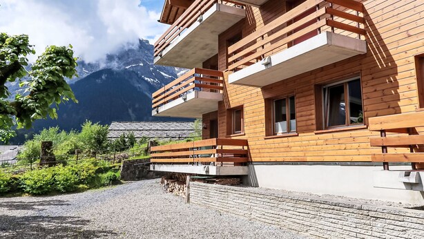 A wooden building with balconies overlooking a mountainous landscape. - Pavillons A by Interhome (Champery)