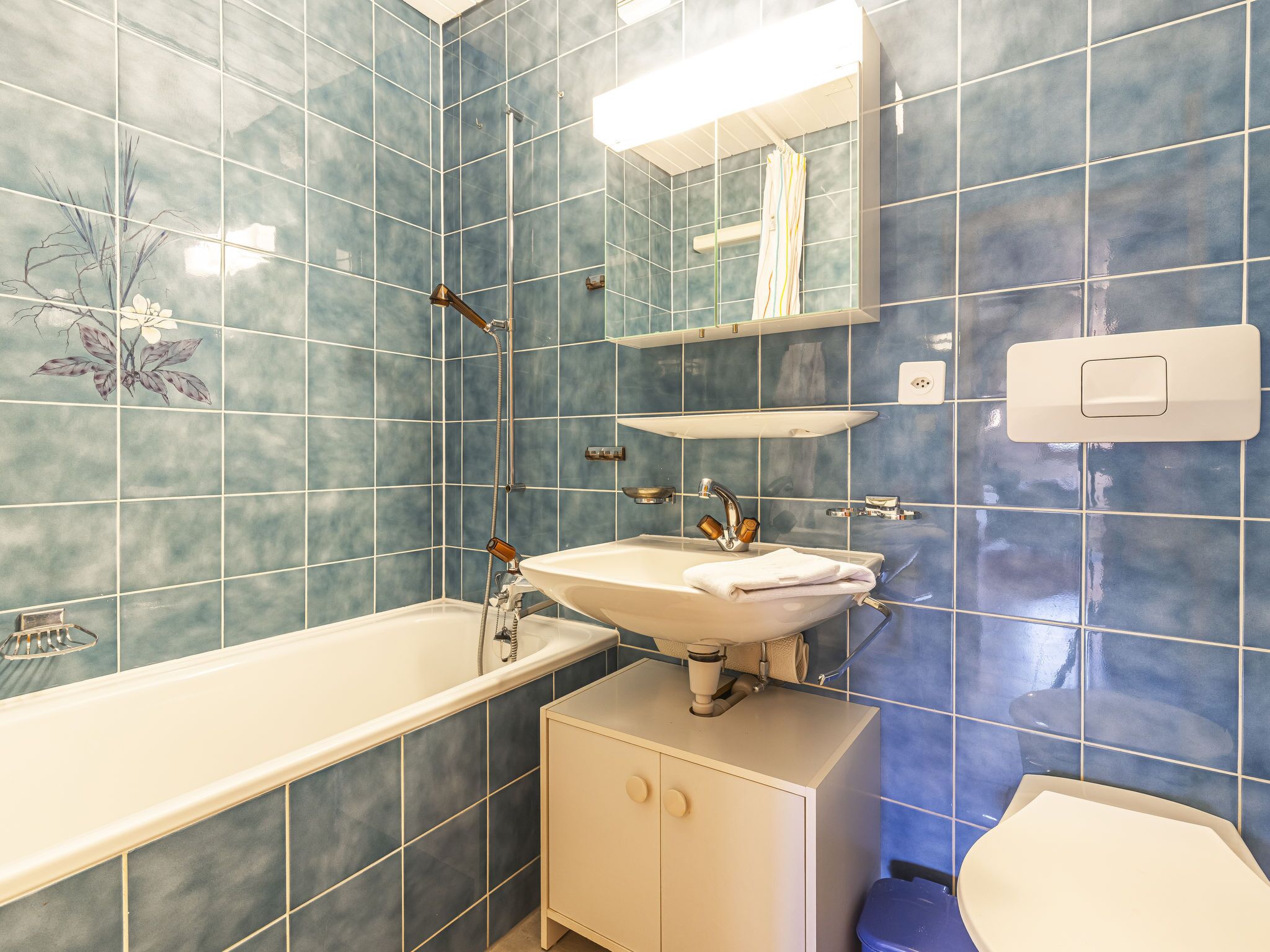 A bathroom with a bathtub, sink, and toilet.