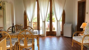 A dining area with a table, chairs, and a refrigerator. - Tuscany Stay with Pool (Montaione)