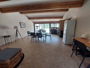 Enjoy meals in the spacious dining area with a glass-top table and multiple chairs.