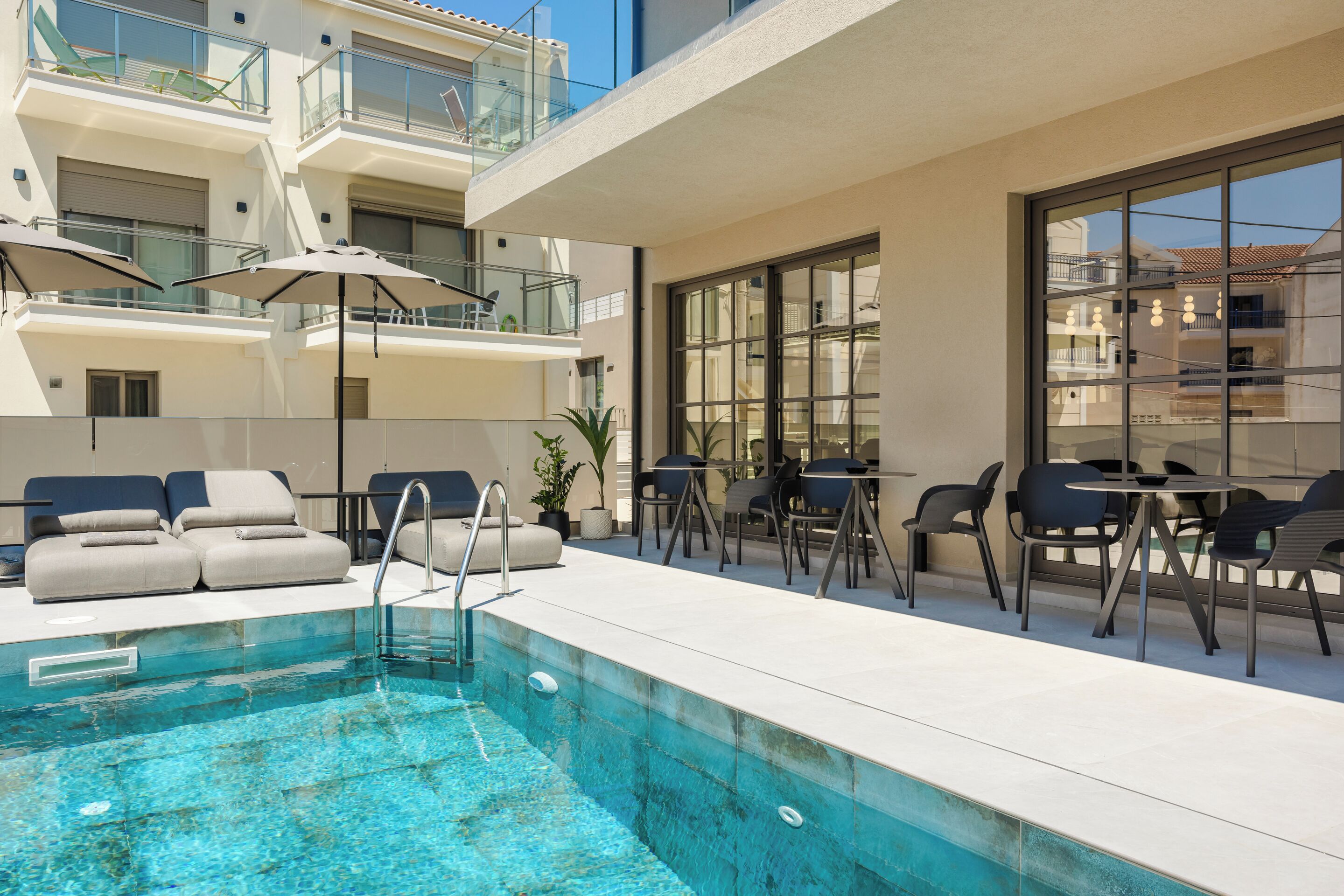 Seasonal outdoor pool, open 11:00 AM to 7:00 PM, pool umbrellas