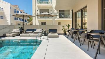 Seasonal outdoor pool, open 11:00 AM to 7:00 PM, pool umbrellas