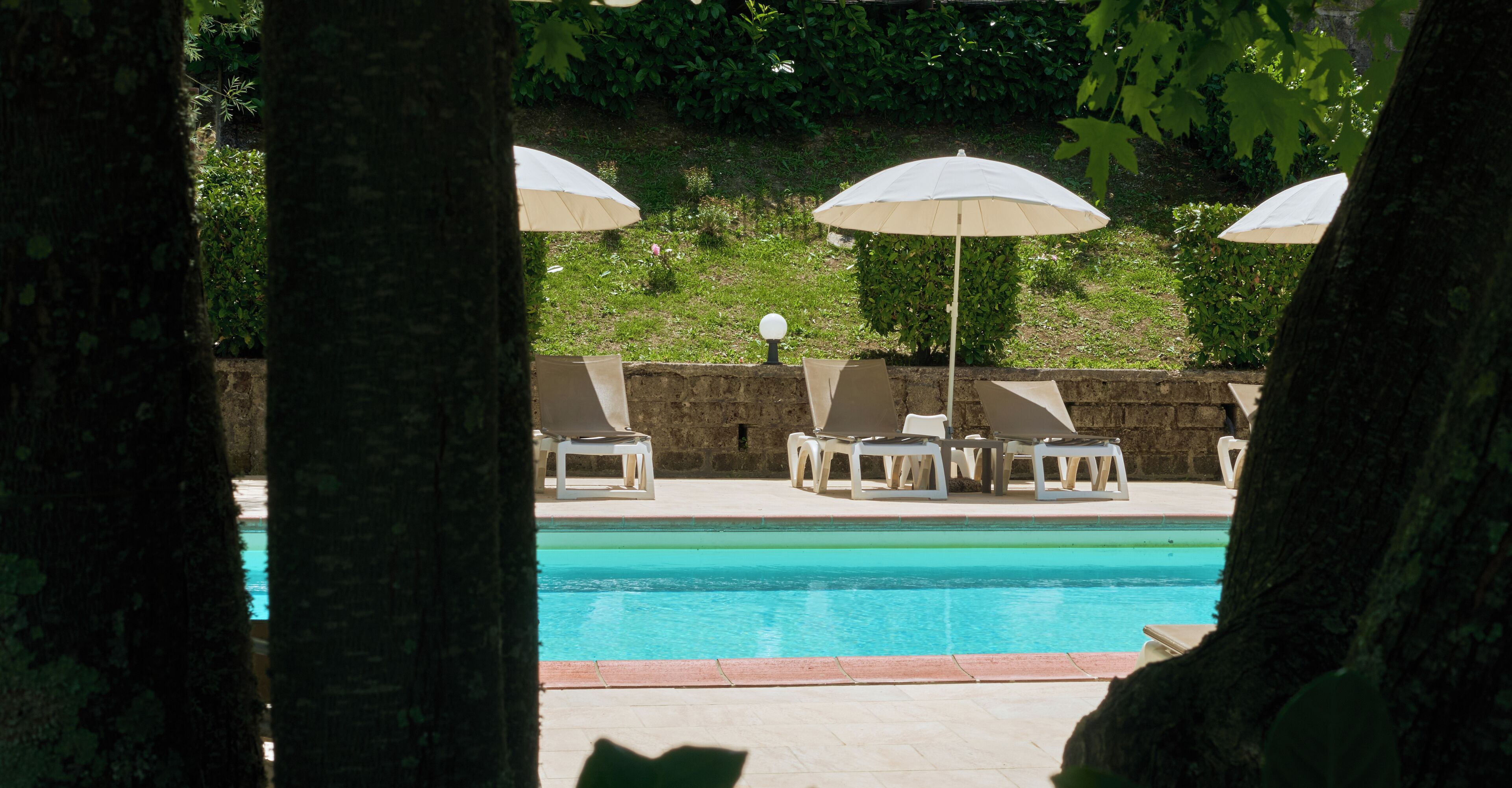 Seasonal outdoor pool, open 9:00 AM to 7:30 PM, pool umbrellas