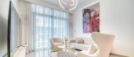 Deluxe Apartment, Balcony, Sea View | Living area | 55-inch Smart TV with cable channels