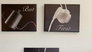 Three framed artworks depicting a coffee cup, a teapot, and a teacup with a saucer.