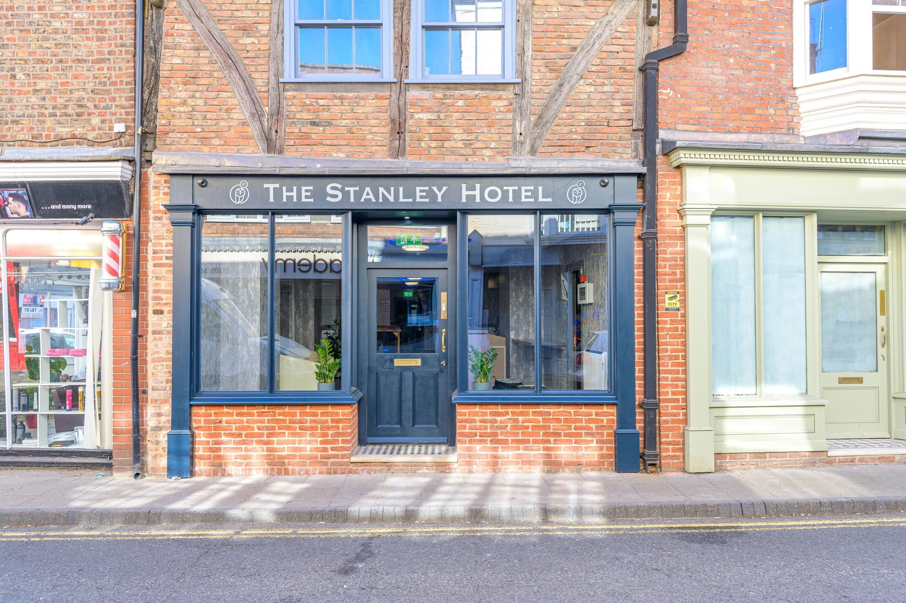 The Stanley Hotel with a traditional brick facade, large windows, and a prominent entrance.